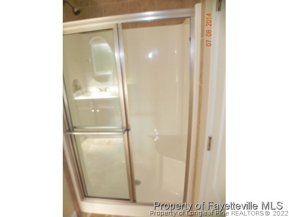 2651 Rockfish Road Raeford, NC 28376 - Photo 21 of 21 a bathroom with a glass shower door