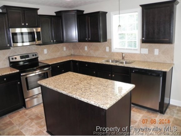 2651 Rockfish Road Raeford, NC 28376 - Photo 6 of 21 a kitchen with a sink and a microwave