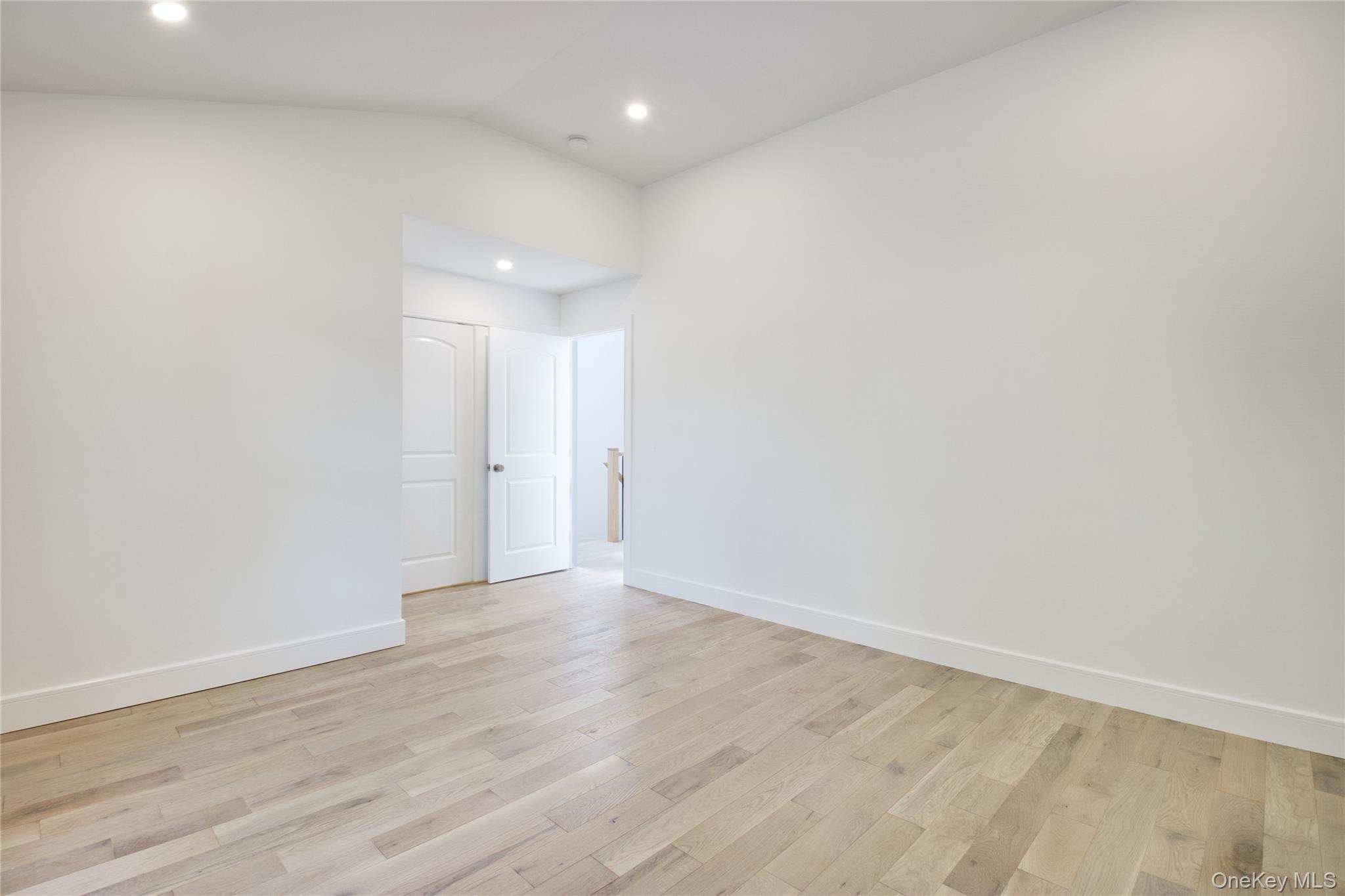 30 Kirkwood Road, Unit B Port Washington, NY 11050 - Photo 23 of 36 a view of an empty room with wooden floor
