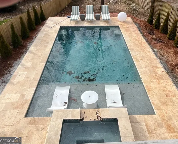 a backyard of a house with barbeque oven table and chairs