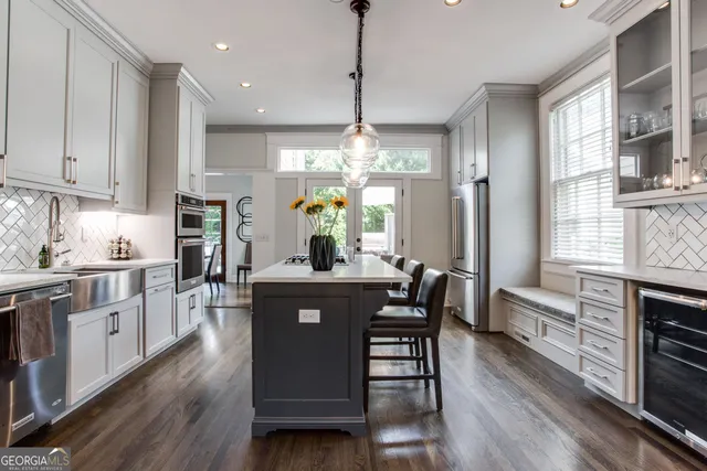 a bedroom with a bed a chandelier and a dresser
