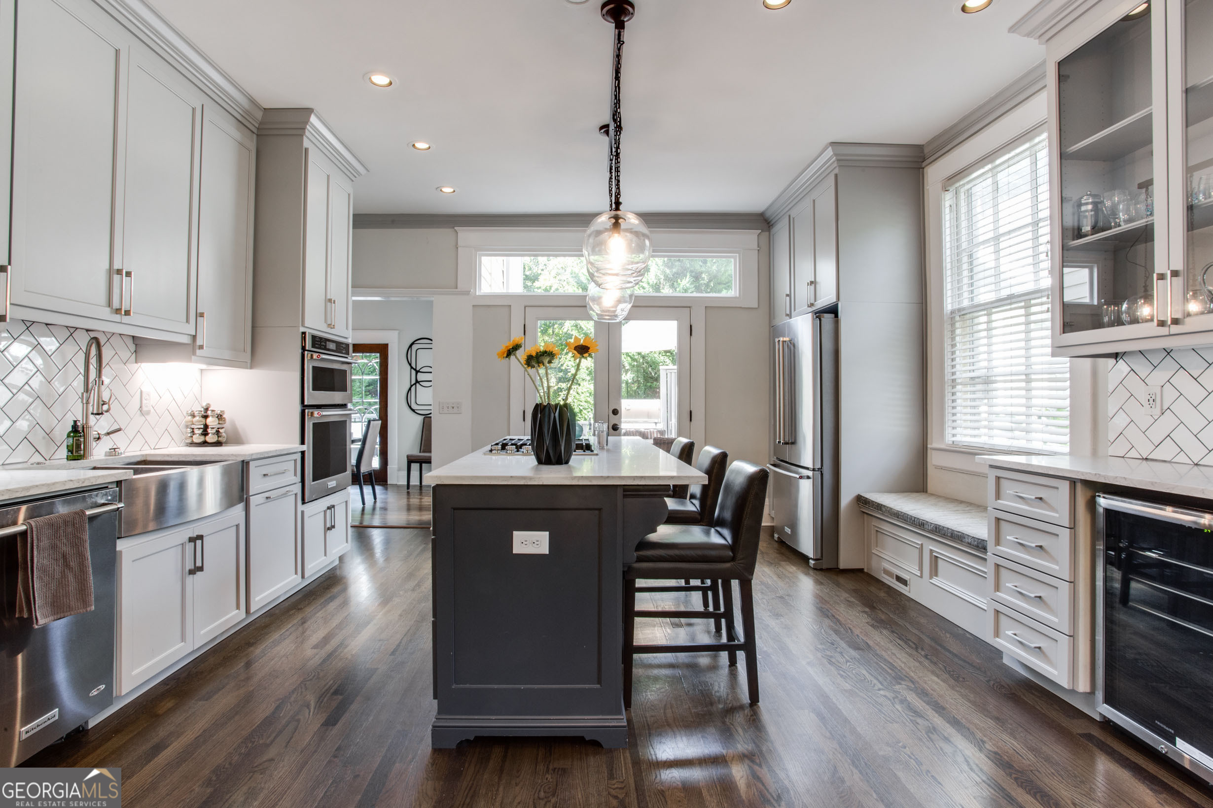 524 Seminole Avenue Northeast Atlanta, GA 30307 - Photo 20 of 75 a kitchen with stainless steel appliances granite countertop a stove a refrigerator a kitchen island a dining table and chairs with wooden floor