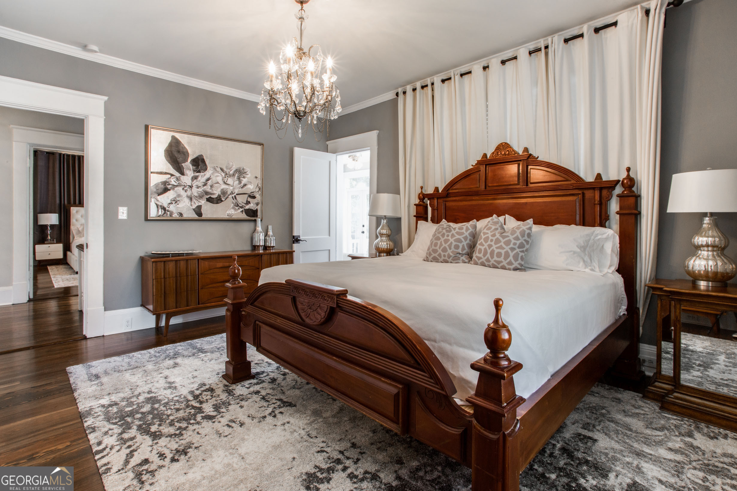 524 Seminole Avenue Northeast Atlanta, GA 30307 - Photo 31 of 75 a bedroom with a bed a chandelier and a dresser