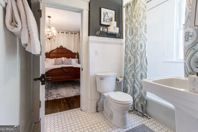 a large bed in a bedroom next to a lamp