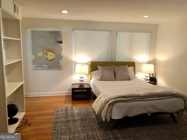 a view of a backyard with a table and chairs under an umbrella