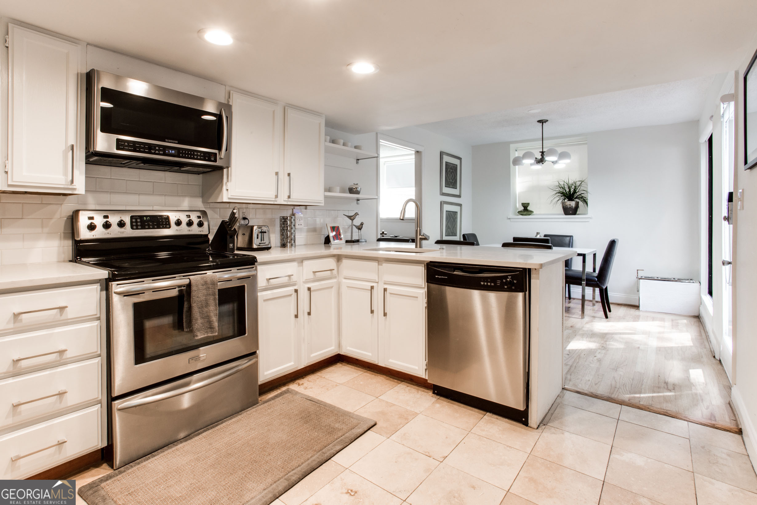 524 Seminole Avenue Northeast Atlanta, GA 30307 - Photo 49 of 75 a kitchen with stainless steel appliances a stove sink microwave and cabinets