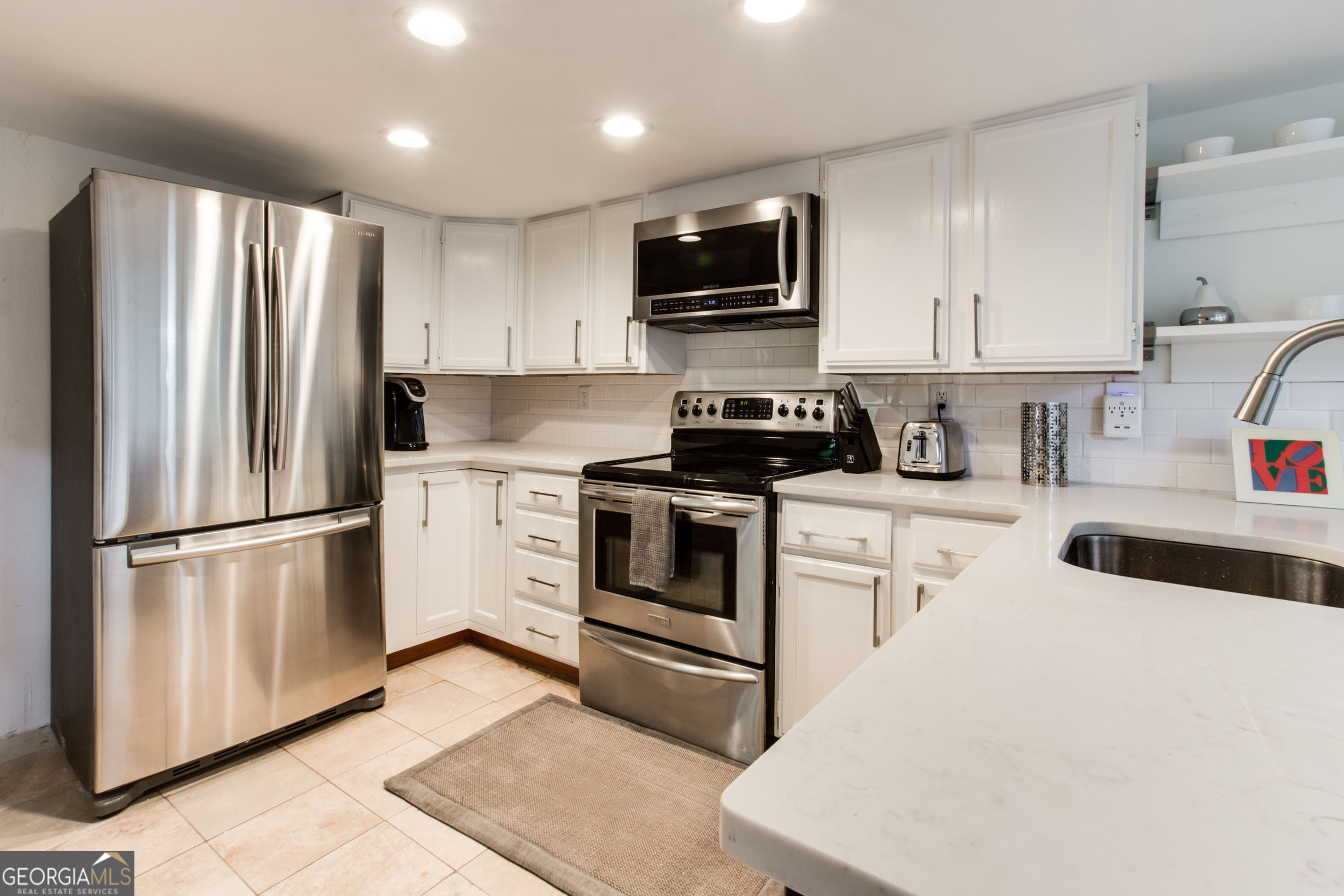524 Seminole Avenue Northeast Atlanta, GA 30307 - Photo 50 of 75 a kitchen with refrigerator a microwave a sink and cabinets