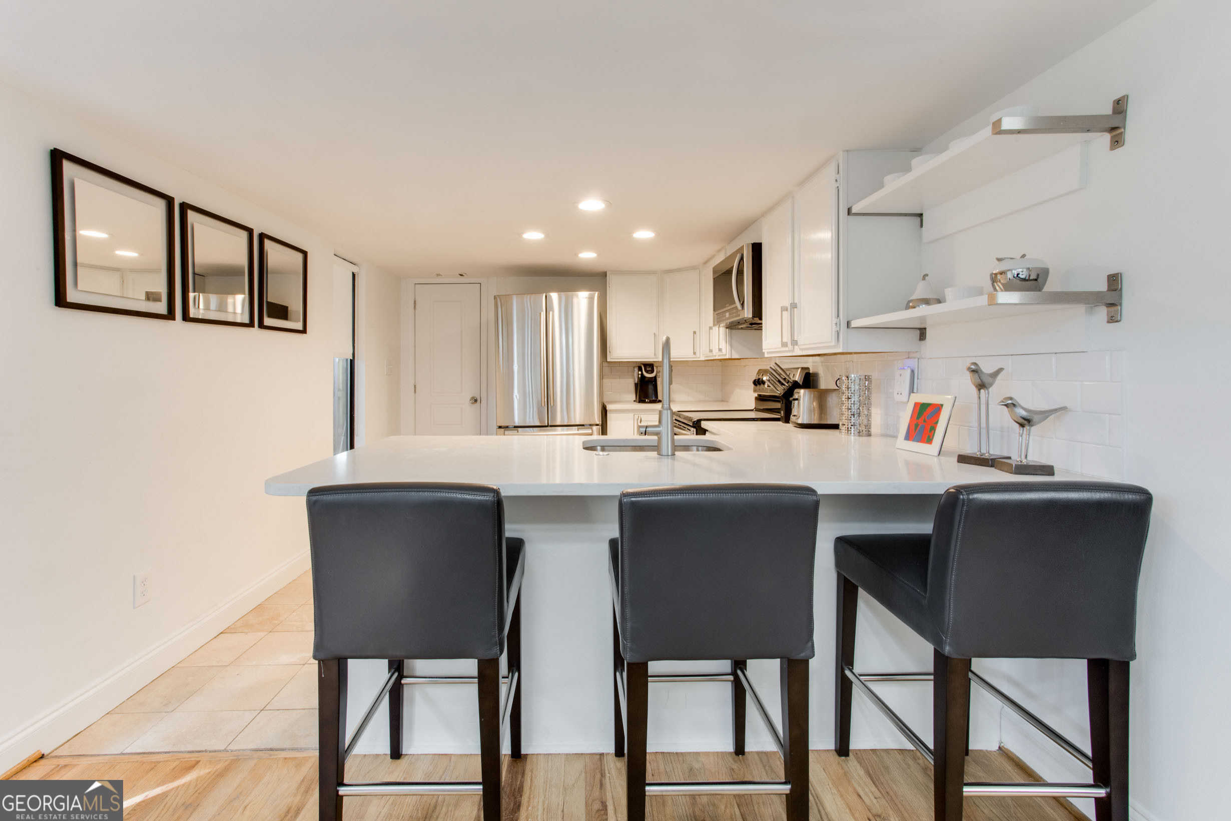 524 Seminole Avenue Northeast Atlanta, GA 30307 - Photo 51 of 75 a kitchen with a dining table chairs and cabinets