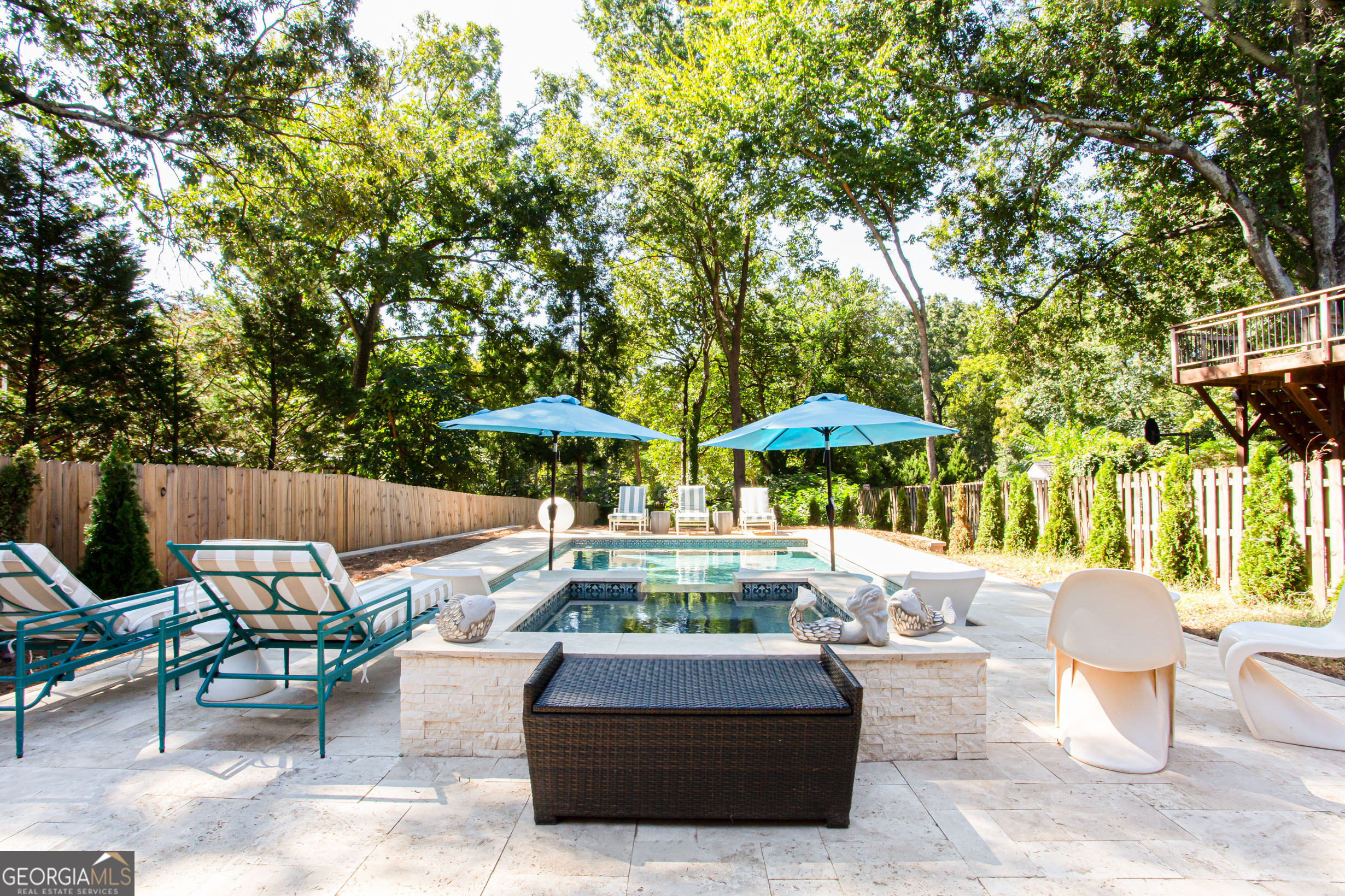 524 Seminole Avenue Northeast Atlanta, GA 30307 - Photo 68 of 75 a patio with a table and chairs under an umbrella