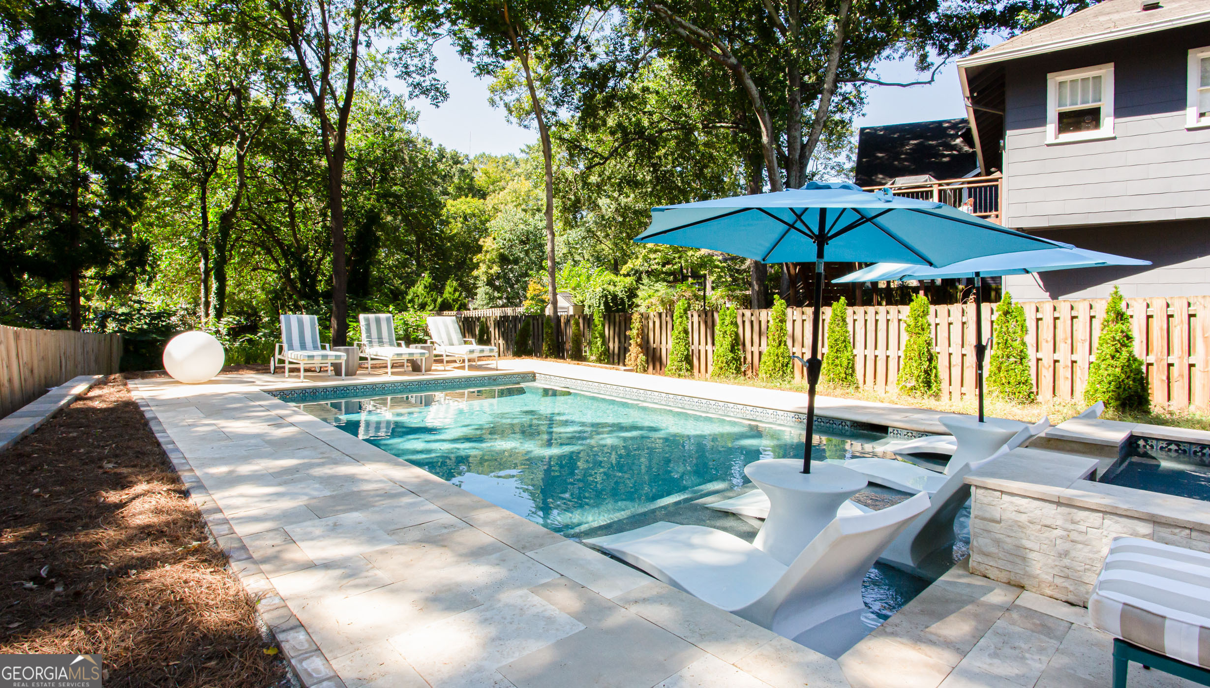 524 Seminole Avenue Northeast Atlanta, GA 30307 - Photo 69 of 75 a view of a backyard with a table and chairs under an umbrella