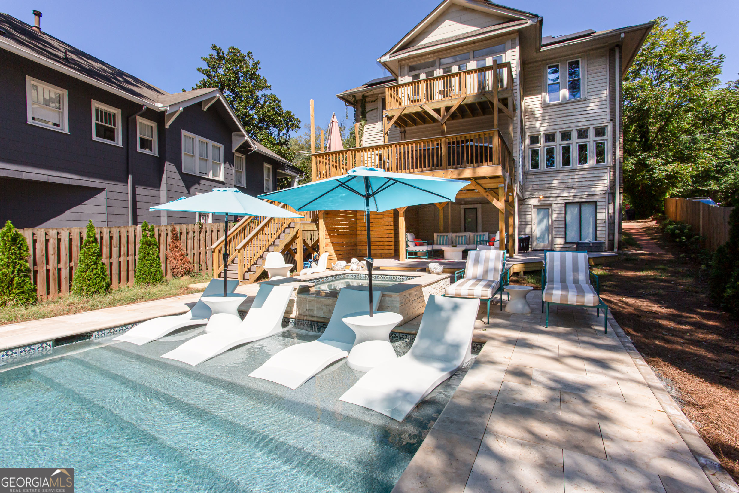 524 Seminole Avenue Northeast Atlanta, GA 30307 - Photo 70 of 75 a view of a patio with chairs and a table under an umbrella
