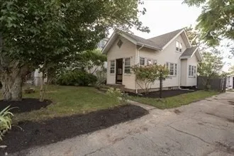 a view of a house with yard and a garden