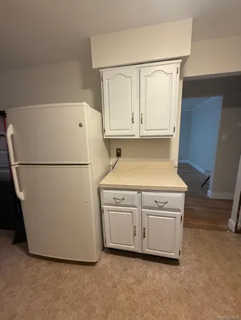 a white refrigerator freezer and a dishwasher sitting in a kitchen