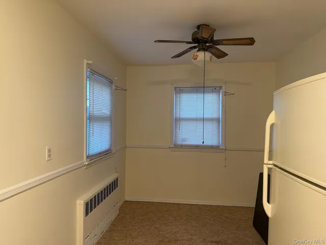 a room with a refrigerator and a window