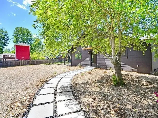 a street sign on a sidewalk next to a road