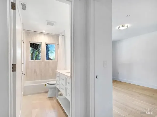 a bathroom with a toilet tub and a shower