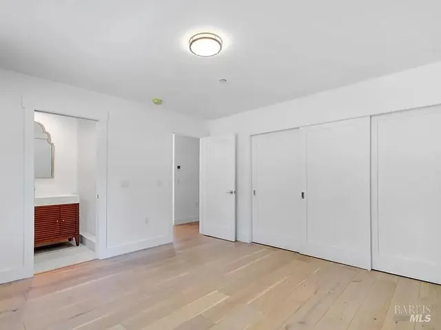 a view of an empty room and wooden floor