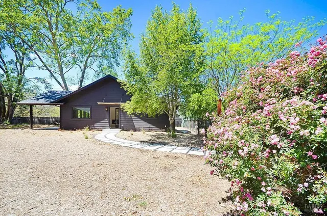 a wooden house with large trees