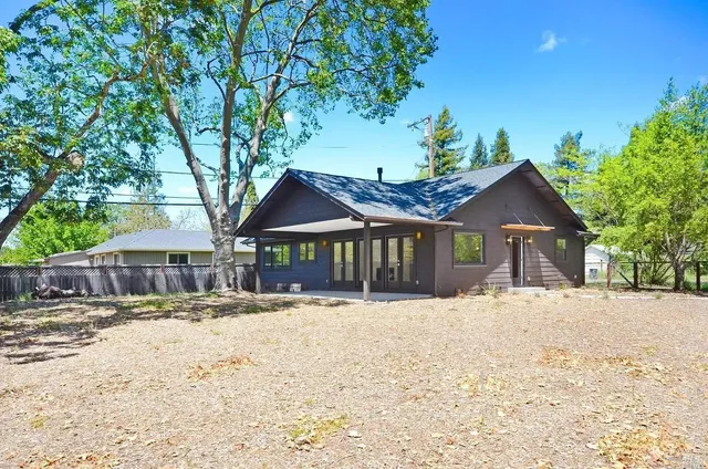 a front view of a house with a yard covered in snow