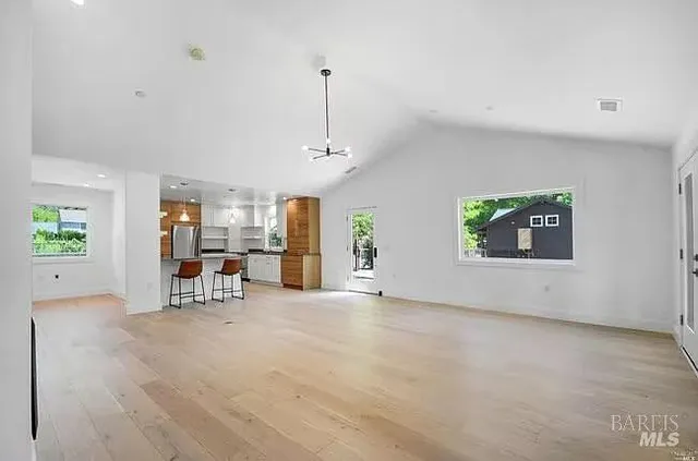 a view of a livingroom with furniture and a ceiling fan