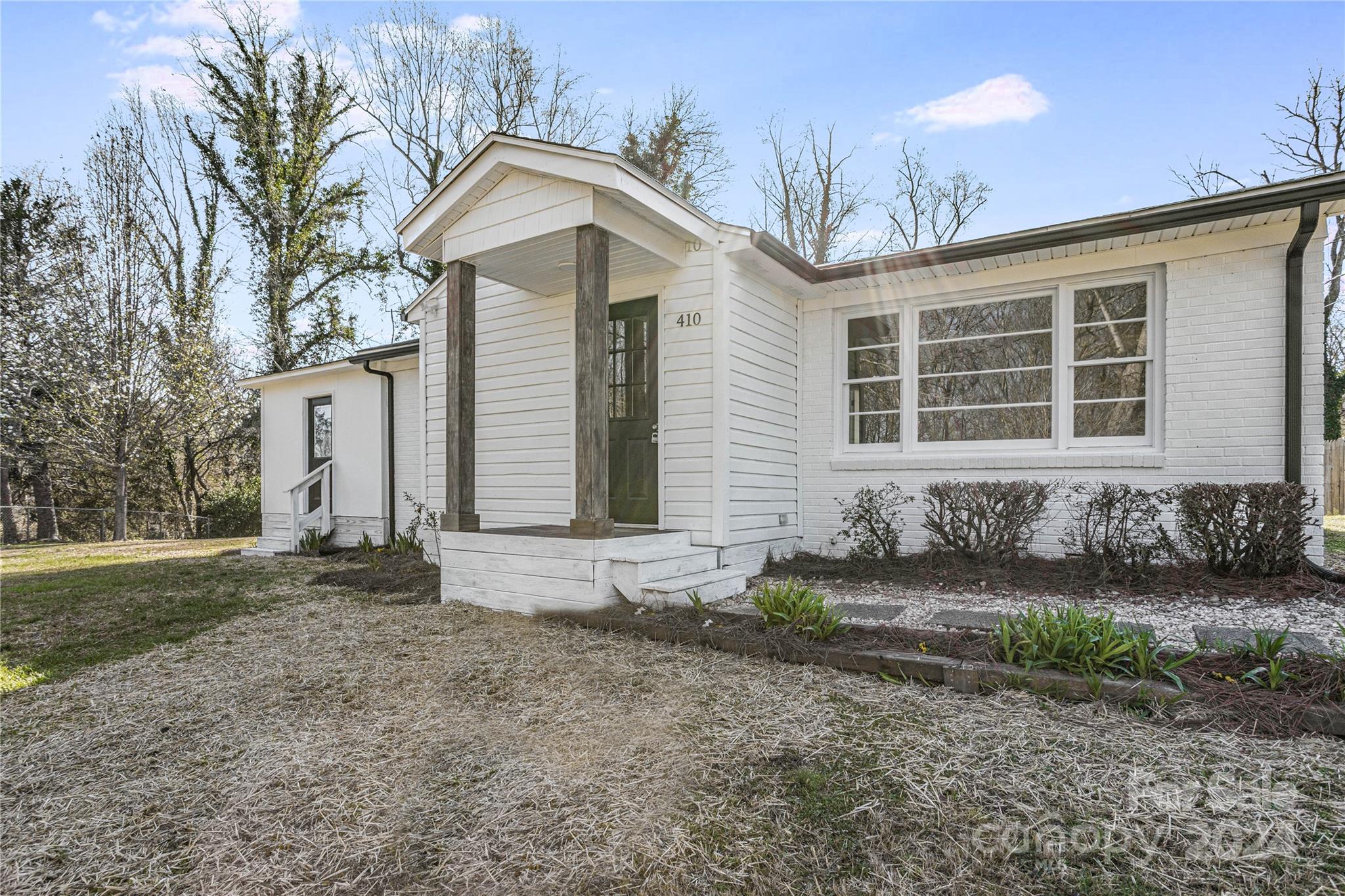 410 Holly Hills Road Dallas, NC 28034 - Photo 1 of 27 a front view of a house with garden