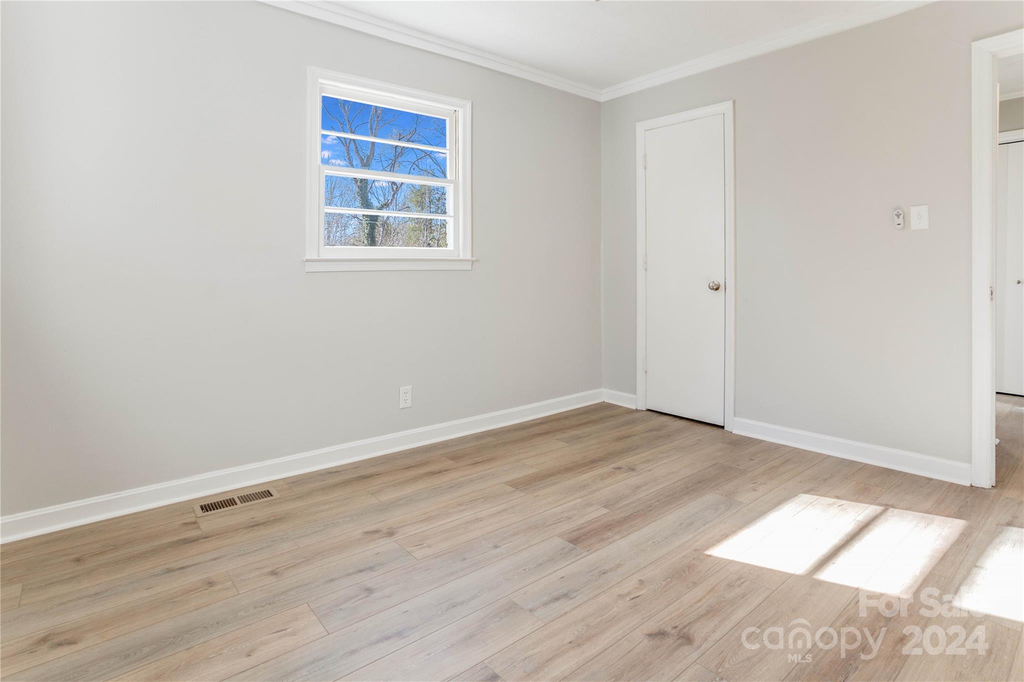 410 Holly Hills Road Dallas, NC 28034 - Photo 12 of 27 an empty room with wooden floor and windows