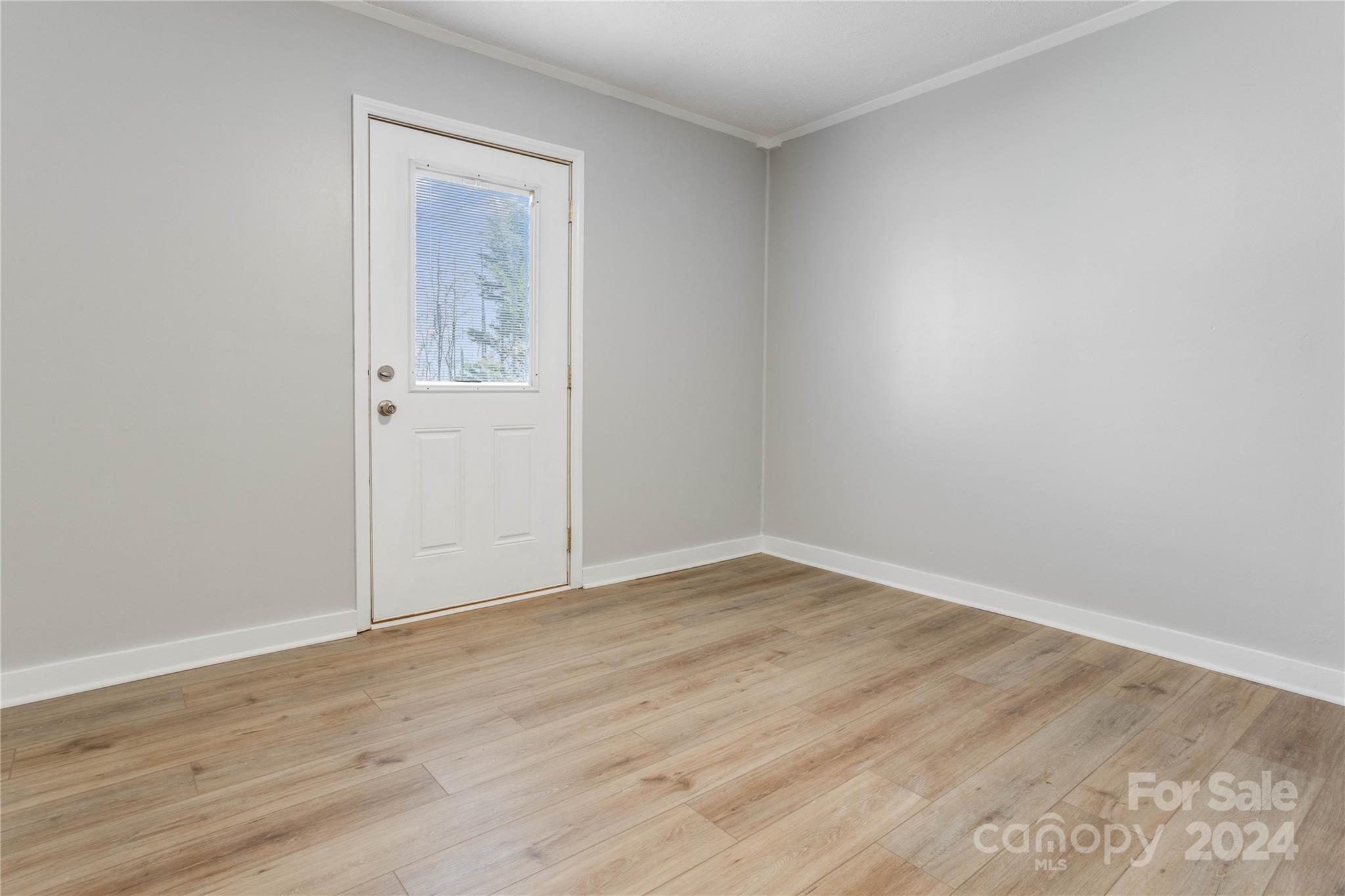 410 Holly Hills Road Dallas, NC 28034 - Photo 14 of 27 a view of an empty room with wooden floor and a window