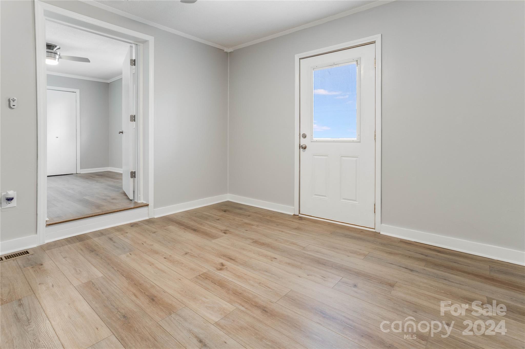 410 Holly Hills Road Dallas, NC 28034 - Photo 15 of 27 a view of an empty room with wooden floor and mirror