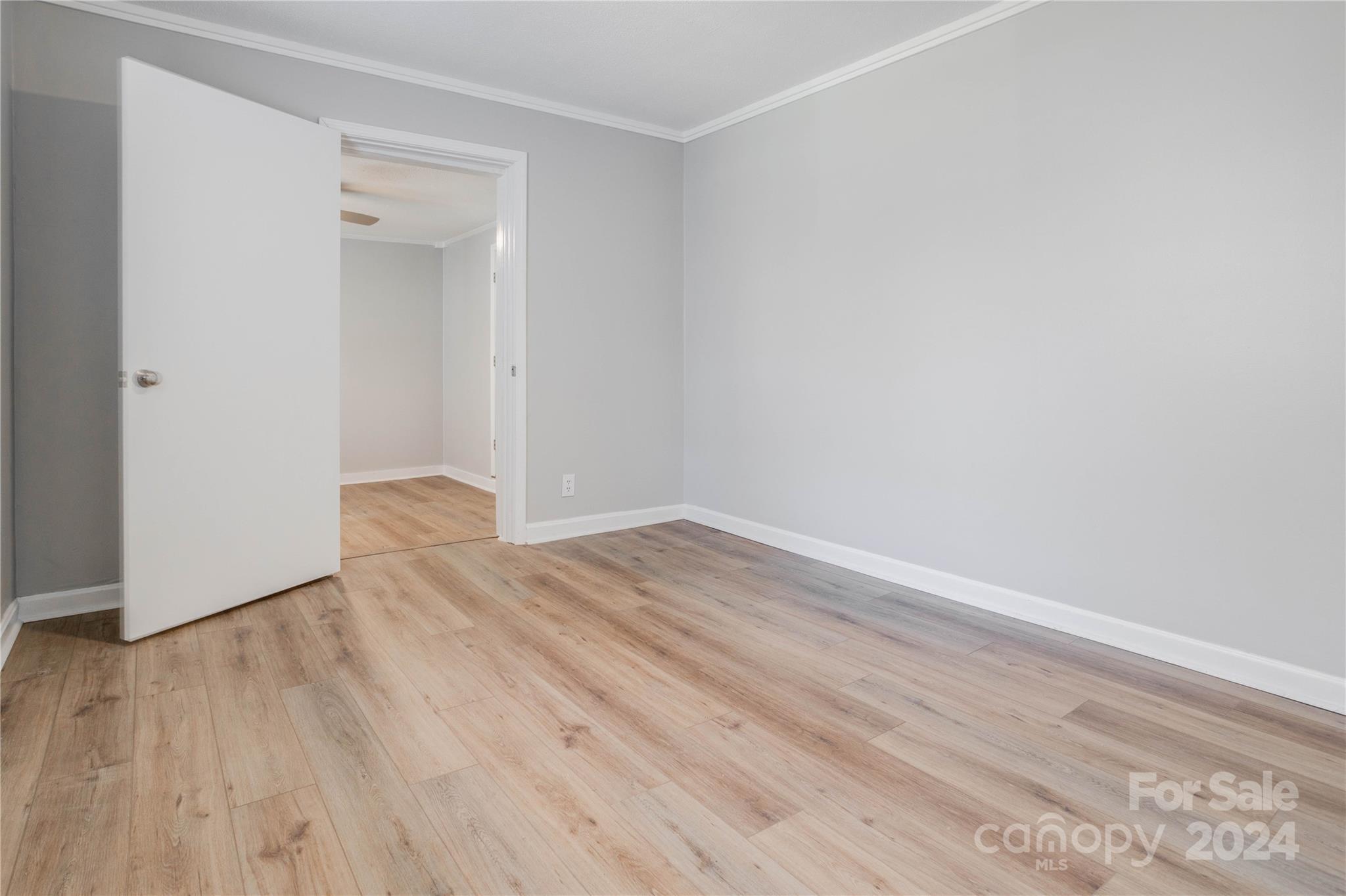 410 Holly Hills Road Dallas, NC 28034 - Photo 16 of 27 an empty room with wooden floor and windows