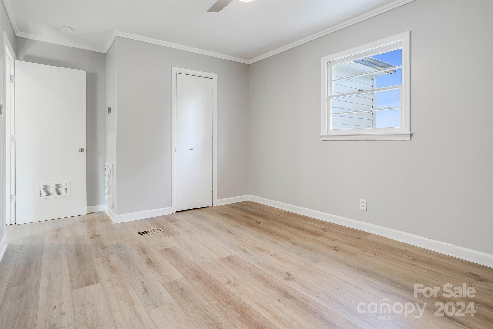 410 Holly Hills Road Dallas, NC 28034 - Photo 17 of 27 a view of an empty room with wooden floor and a window