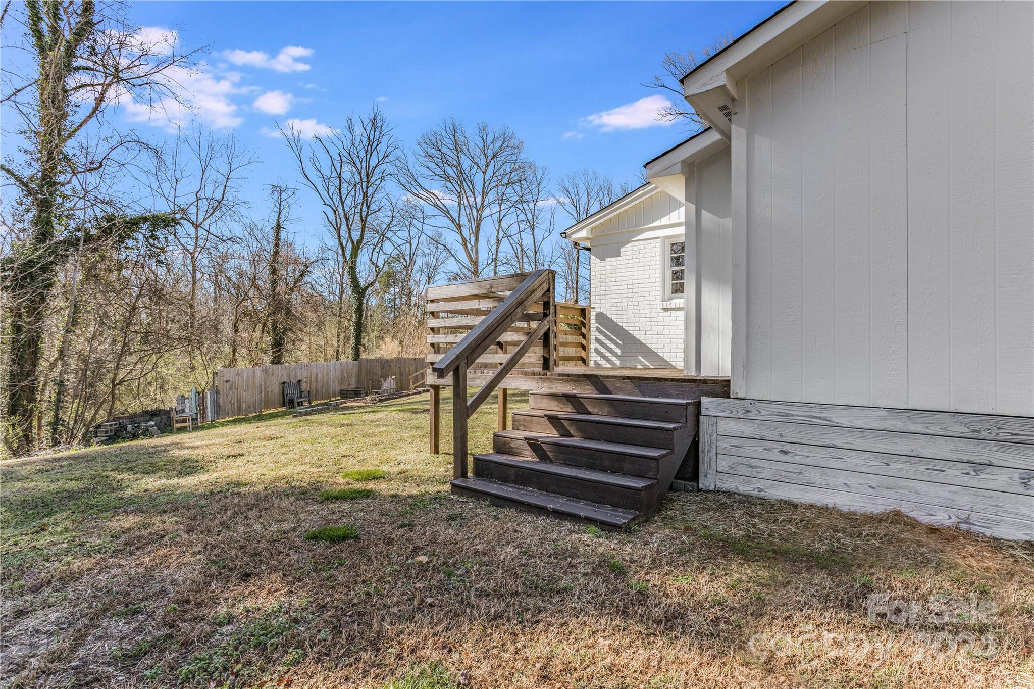 410 Holly Hills Road Dallas, NC 28034 - Photo 21 of 27 a view of a backyard with stairs and a bench