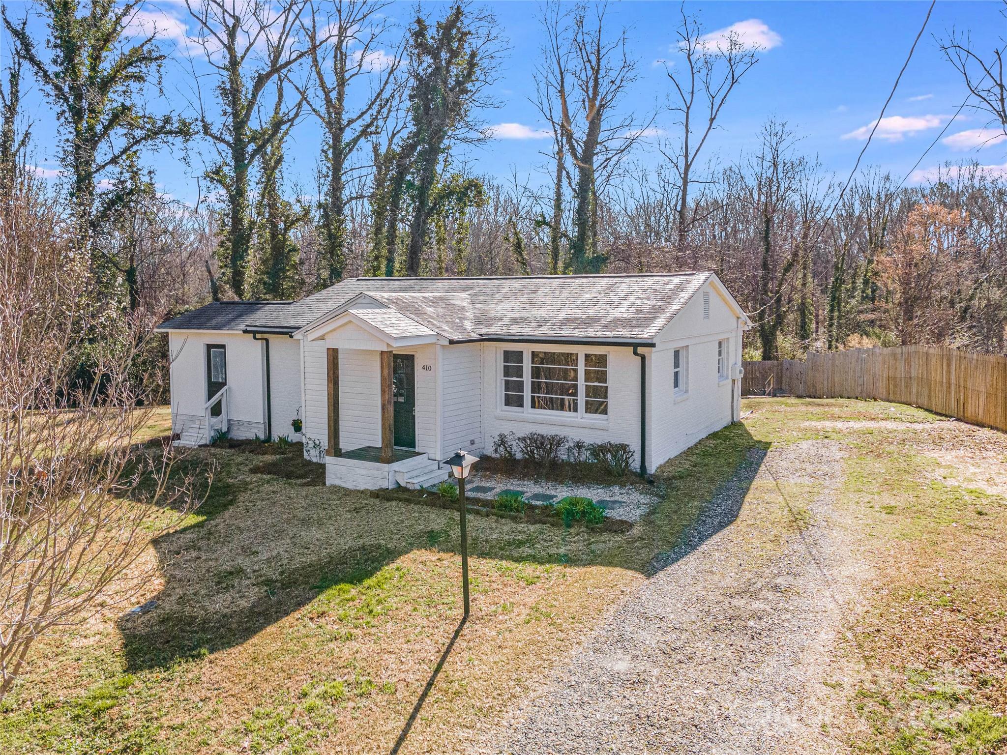 410 Holly Hills Road Dallas, NC 28034 - Photo 24 of 27 a view of a house with backyard and trees