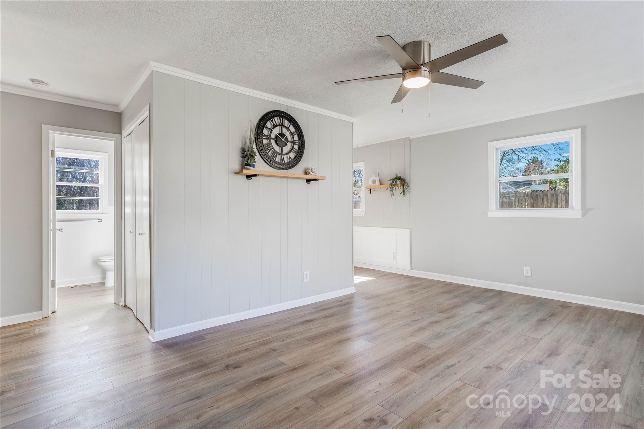 410 Holly Hills Road Dallas, NC 28034 - Photo 4 of 27 an empty room with wooden floor and a ceiling fan