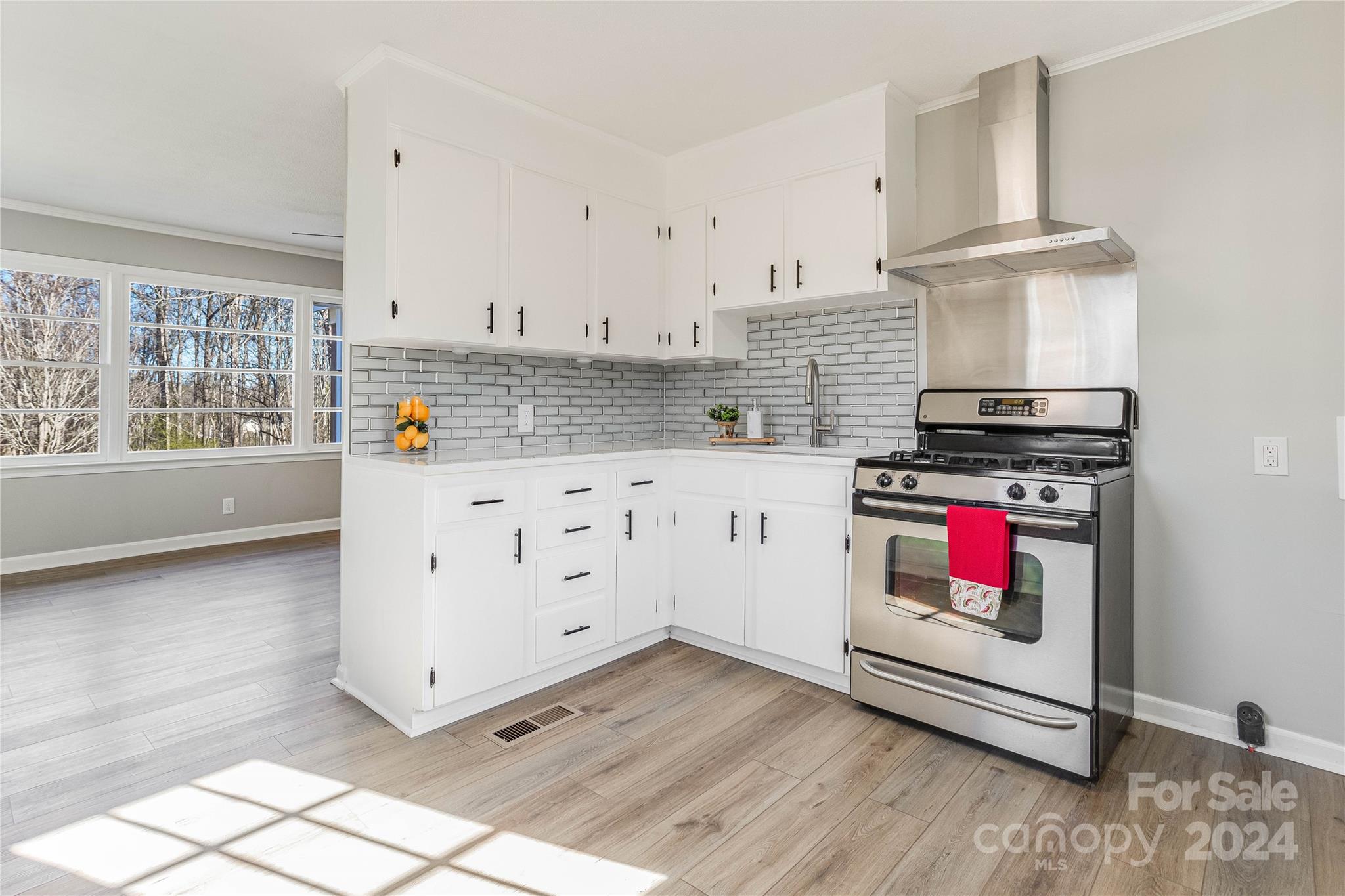 410 Holly Hills Road Dallas, NC 28034 - Photo 8 of 27 a kitchen with stainless steel appliances a stove and a refrigerator