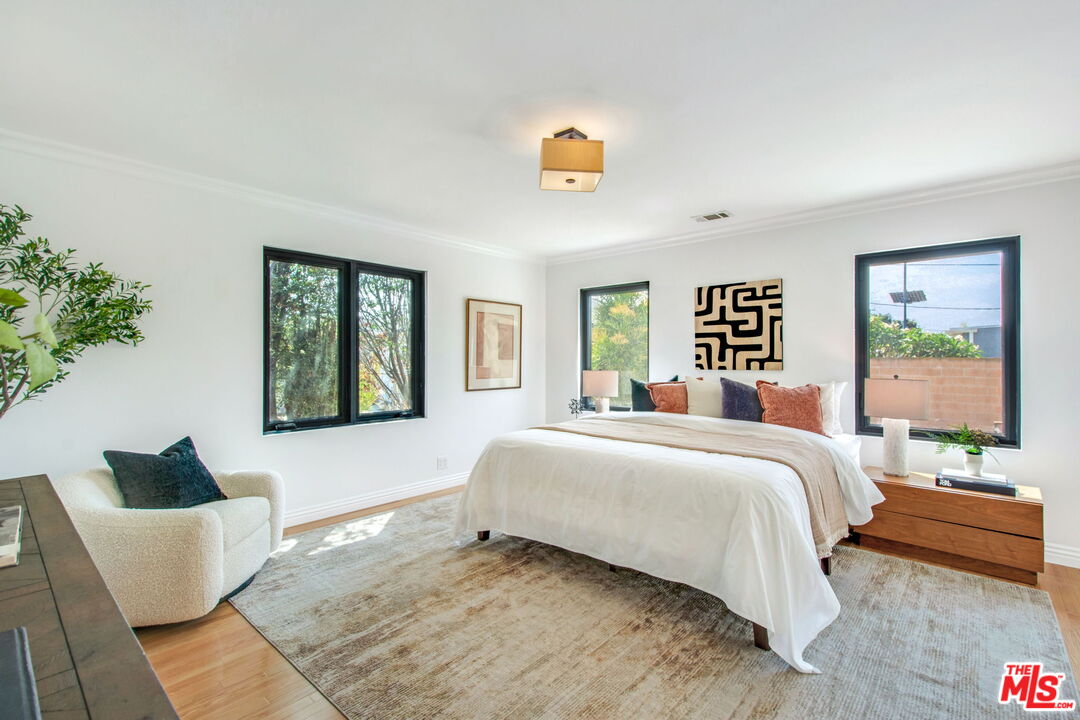 3558 Muirfield Road South Los Angeles, CA 90016 - Photo 13 of 23 a bedroom with a bed and a couch