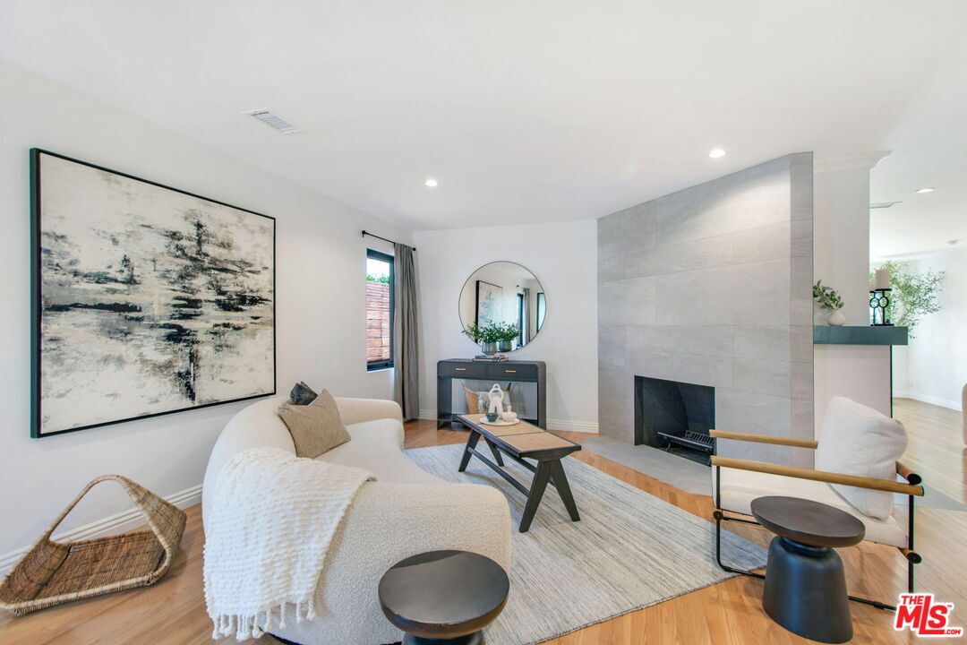 3558 Muirfield Road South Los Angeles, CA 90016 - Photo 2 of 23 a living room with furniture and a fireplace