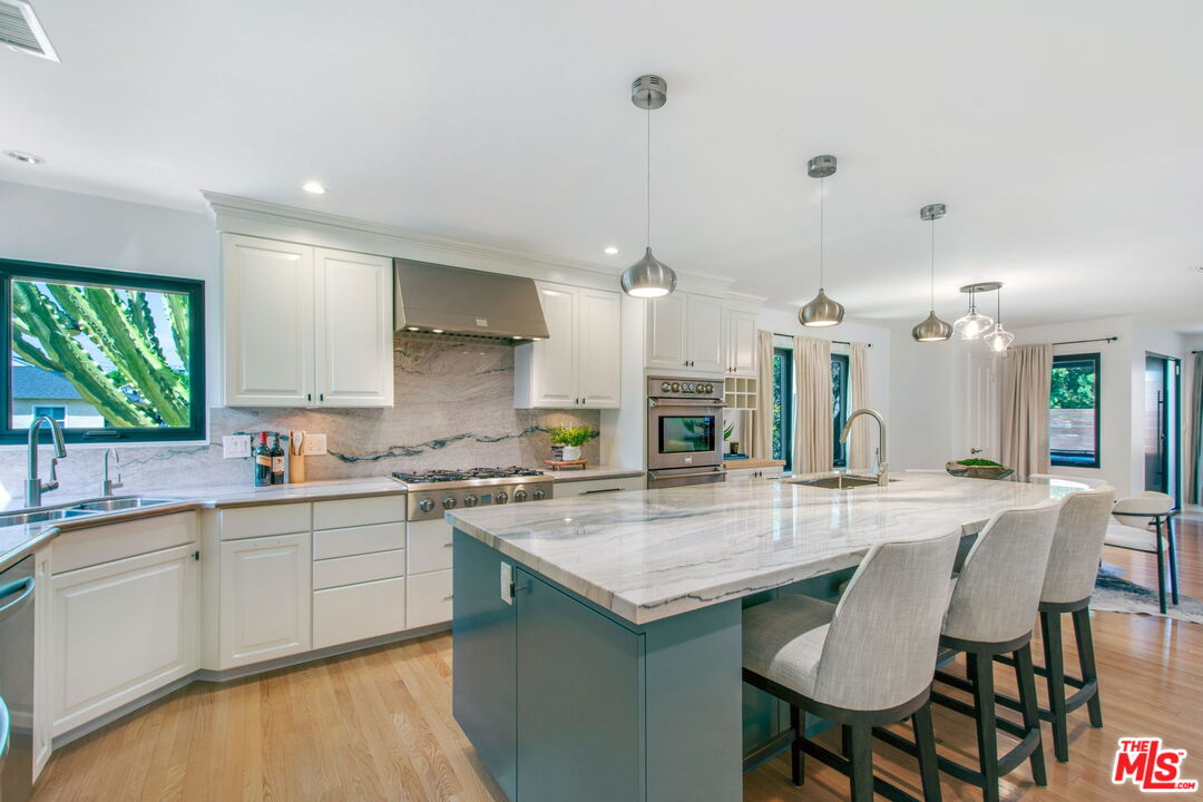 3558 Muirfield Road South Los Angeles, CA 90016 - Photo 21 of 23 a large kitchen with lots of counter space a sink and appliances