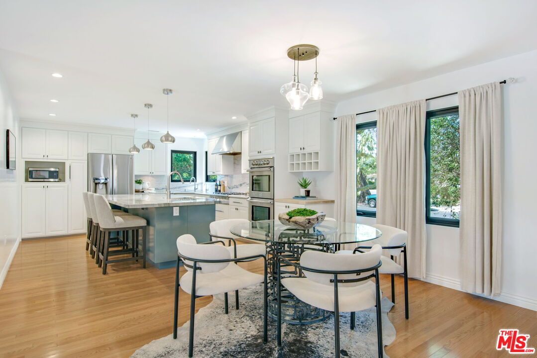 3558 Muirfield Road South Los Angeles, CA 90016 - Photo 3 of 23 a dining room with furniture and wooden floor