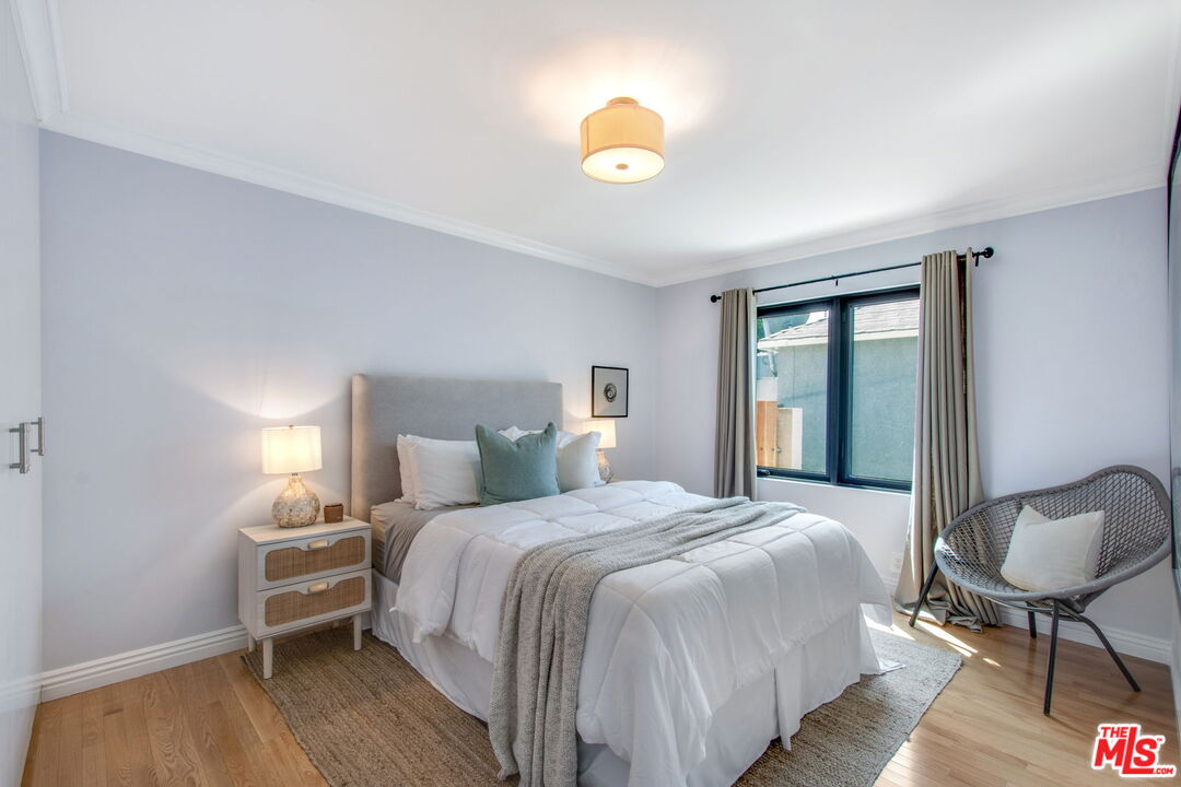 3558 Muirfield Road South Los Angeles, CA 90016 - Photo 7 of 23 a bedroom with a bed and a lamp