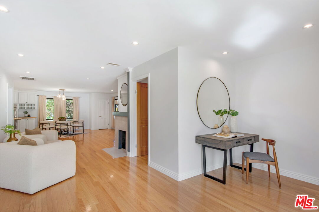 3558 Muirfield Road South Los Angeles, CA 90016 - Photo 9 of 23 a living room with furniture a dining table and wooden floor
