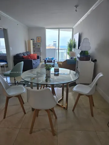 a view of front door with chair and refrigerator
