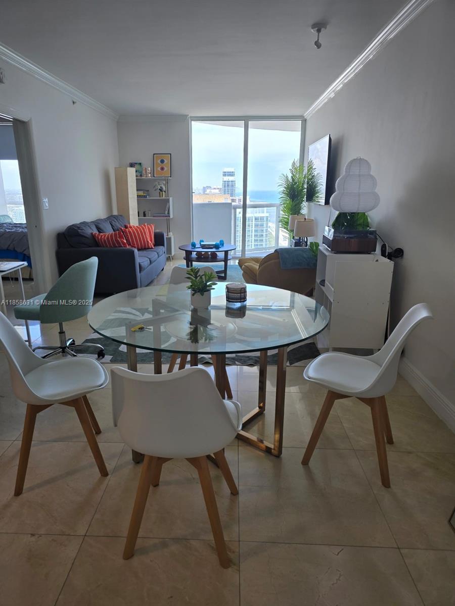 6365 Collins Avenue, Unit 2710 Miami Beach, FL 33141 - Photo 17 of 24 a view of a dining room with furniture window and outside view