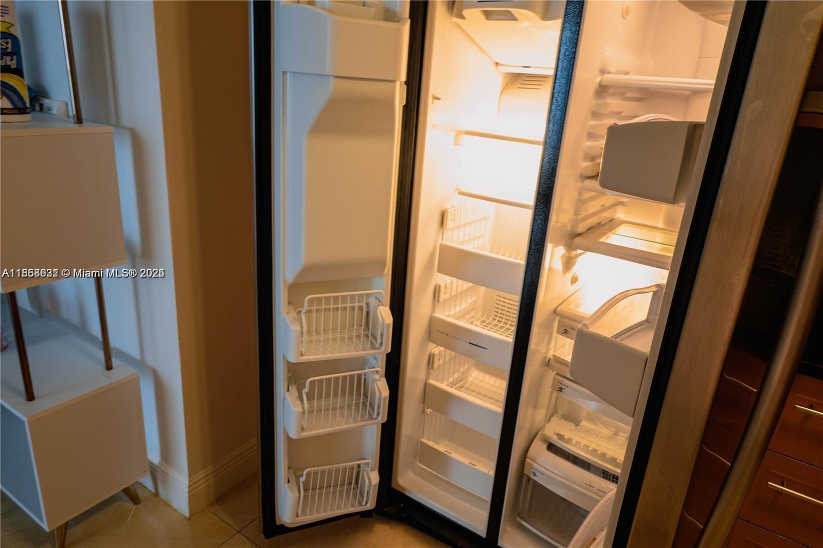 6365 Collins Avenue, Unit 2710 Miami Beach, FL 33141 - Photo 18 of 24 a view of front door with chair and refrigerator