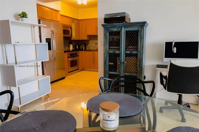 a living room with stainless steel appliances furniture stove and a kitchen view