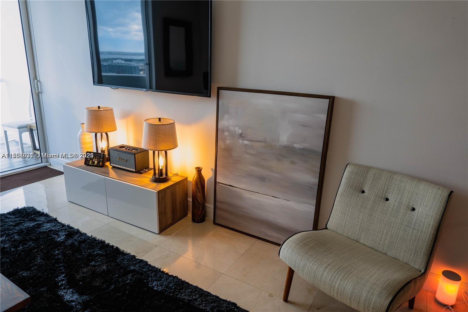 6365 Collins Avenue, Unit 2710 Miami Beach, FL 33141 - Photo 3 of 24 a bathroom with a tub sink and mirror