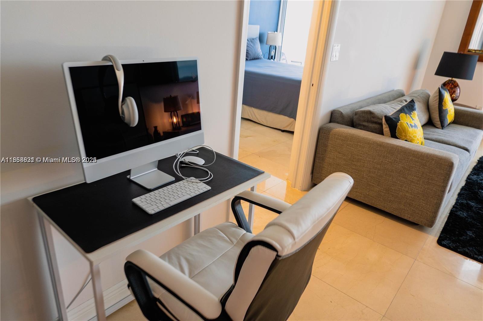6365 Collins Avenue, Unit 2710 Miami Beach, FL 33141 - Photo 7 of 24 a living room with chair and a flat screen tv