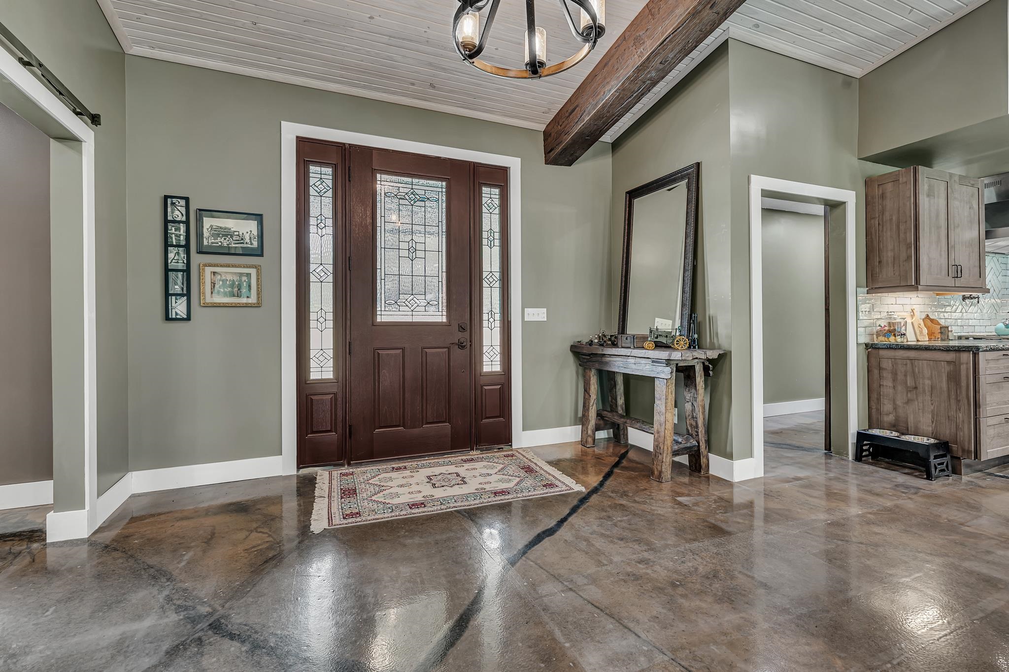 350 Hamilton Road Springville, TN 38256 - Photo 6 of 40 Entryway featuring a wood-panel front door with sidelights and leaded glass inserts, polished concrete flooring, a shiplap ceiling, and an exposed wood beam