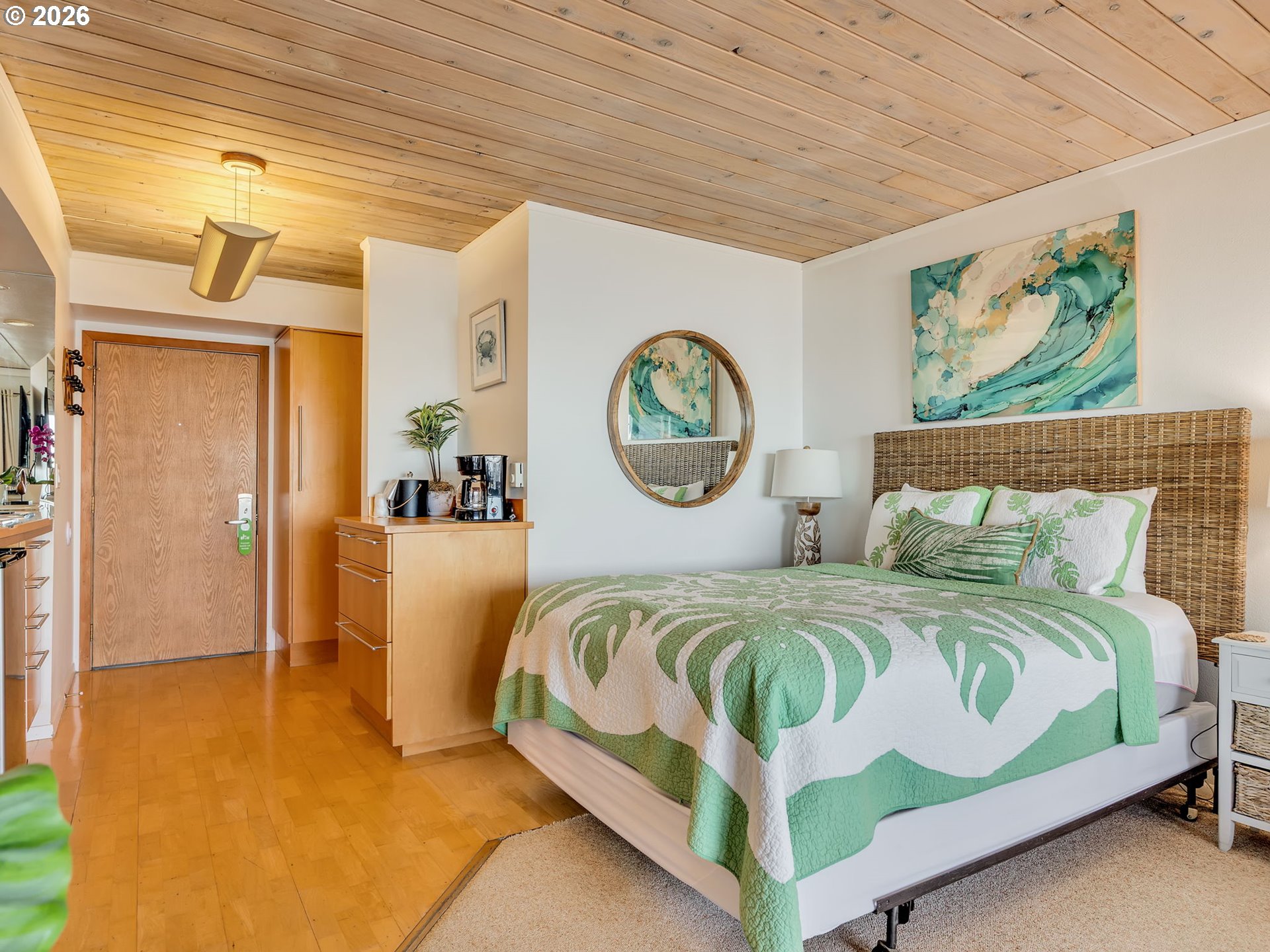 3140 Sunset Boulevard, Unit 36 Seaside, OR 97138 - Photo 17 of 41 a bedroom with a bed a mirror and a window
