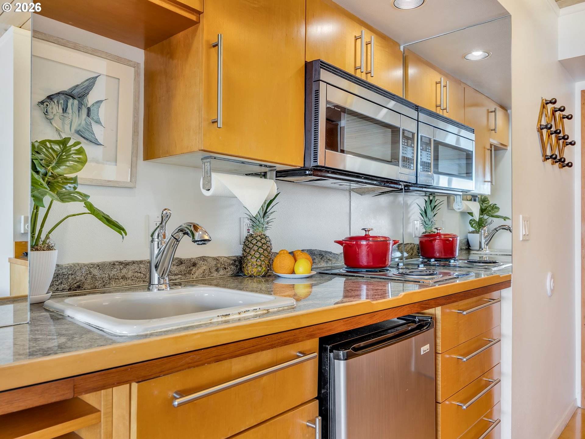 3140 Sunset Boulevard, Unit 36 Seaside, OR 97138 - Photo 22 of 41 a kitchen sink with granite countertop stainless steel appliances a sink and cabinets