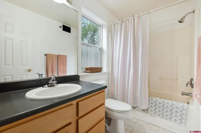 a bathroom with a sink toilet a mirror and shower